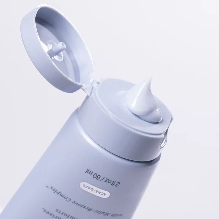 Cosmetic bottle with a pump dispenser on a light gray background